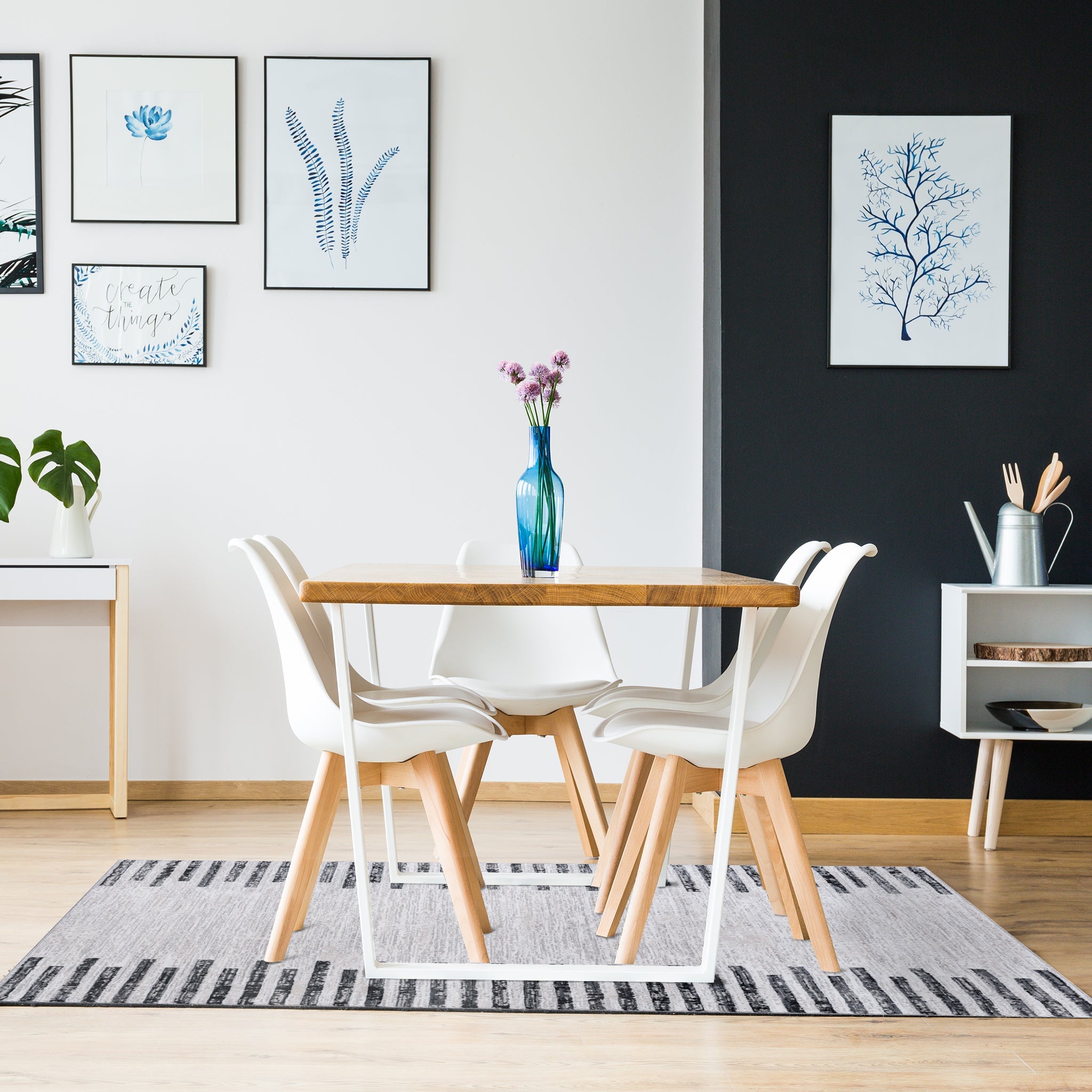 Modern living room with wooden dining table, white chairs on charcoal striped grey rug